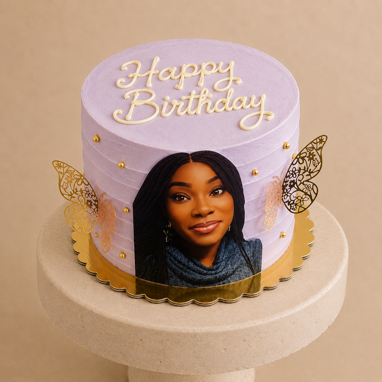 Lilac buttercream birthday cake with combed ridges, gold pearls, gold filigree butterfly decorations, an edible photo print and piped Happy Birthday lettering
